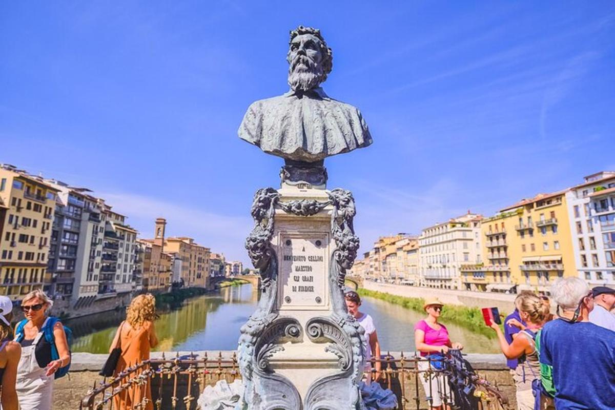 a statue of a man standing on top of a bridge