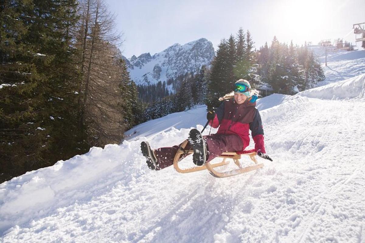 a person sitting on a sled in the snow