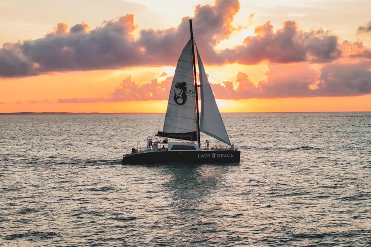a boat in the water with a sunset in the background