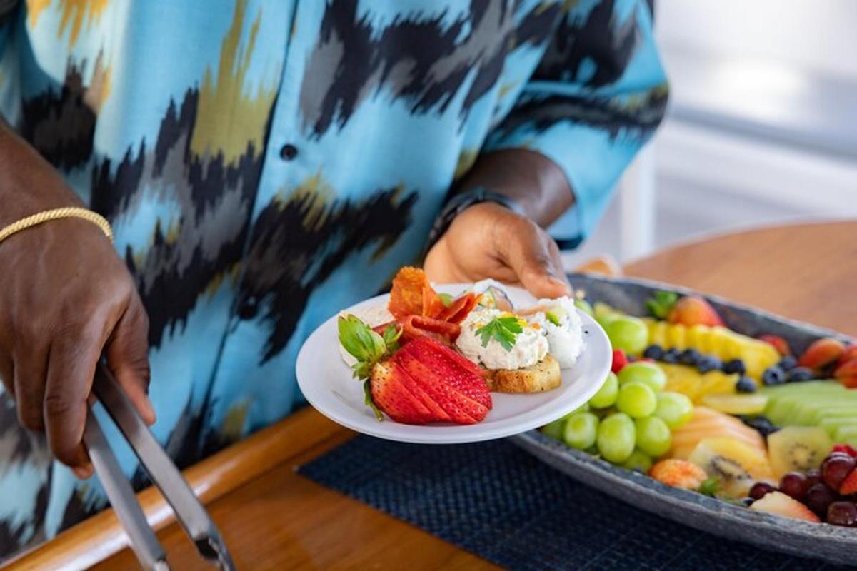a person holding a plate of food with a plate of fruit