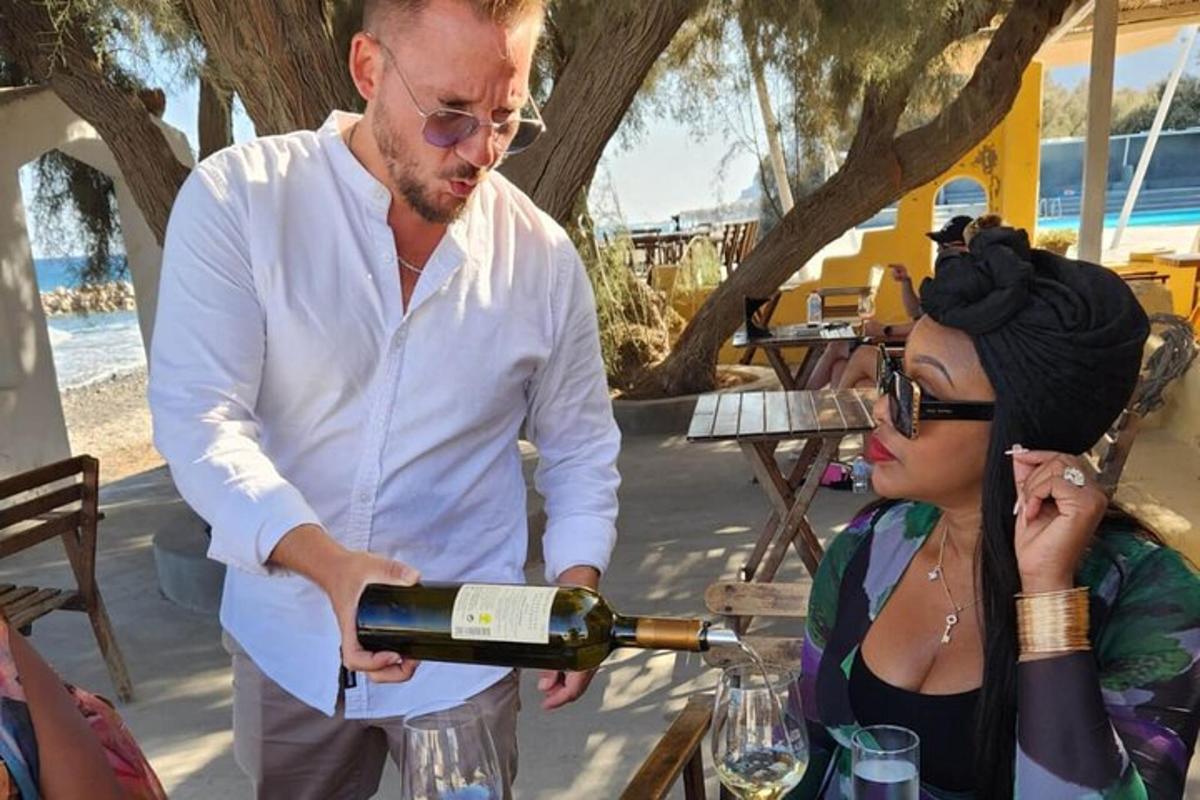 a man pouring a bottle of wine for a woman