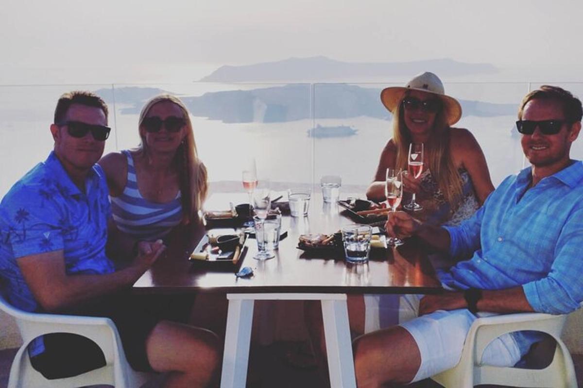 a group of people sitting at a table with wine glasses