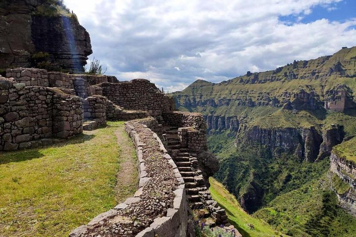 a stone wall on the side of a canyon