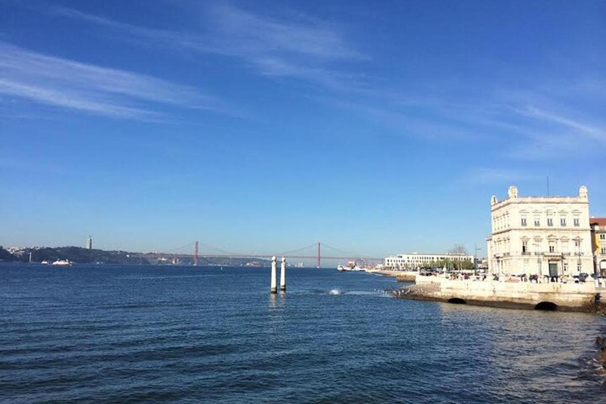 a large body of water with a building and a bridge
