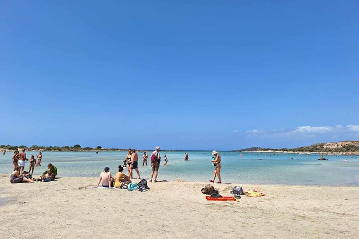 a group of people on a beach near the water