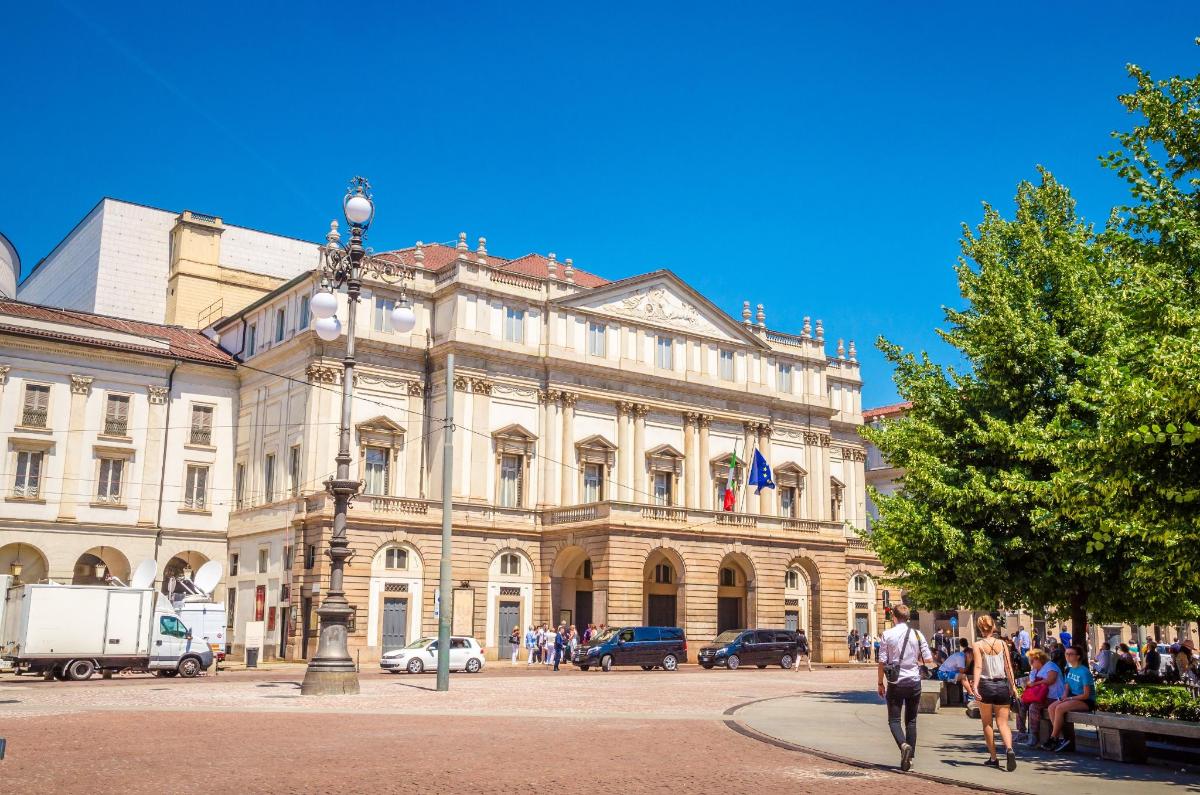 a large building with people walking in front of it