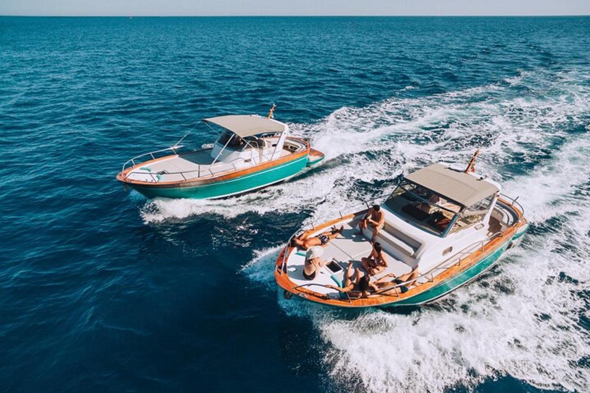 two boats in the water with people on them
