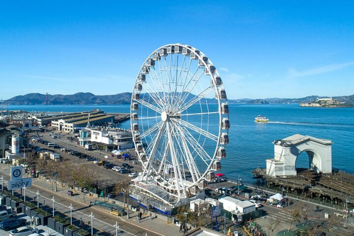 a large ferris wheel in a city next to the water