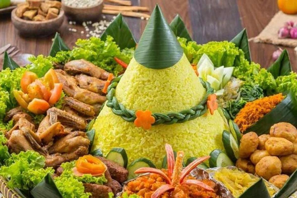 a plate of food with a pineapple with a party hat