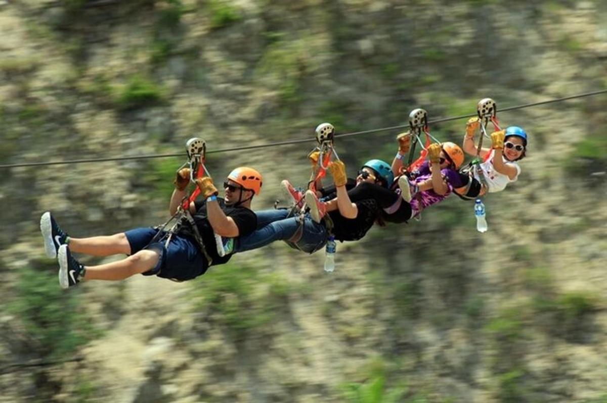 a group of people riding on a zip line