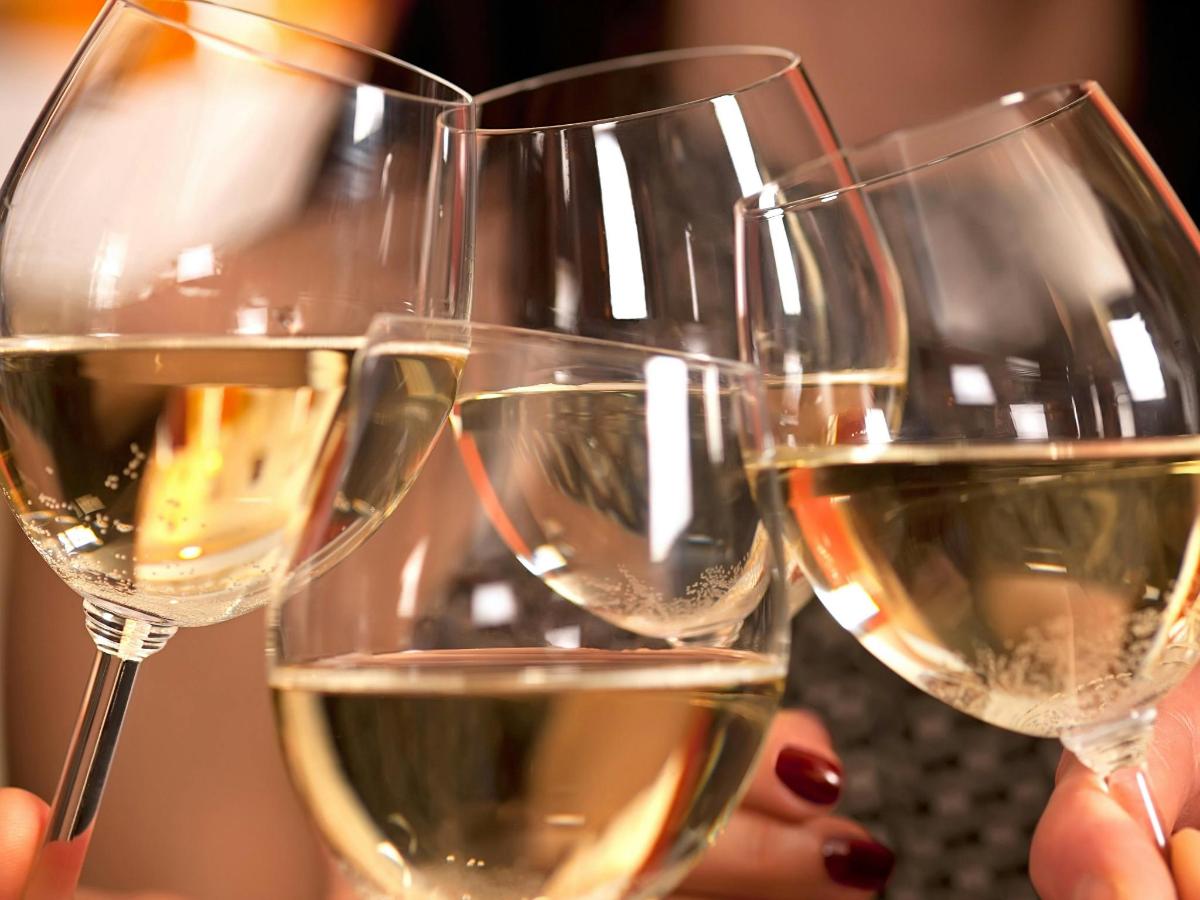a group of three glasses of white wine