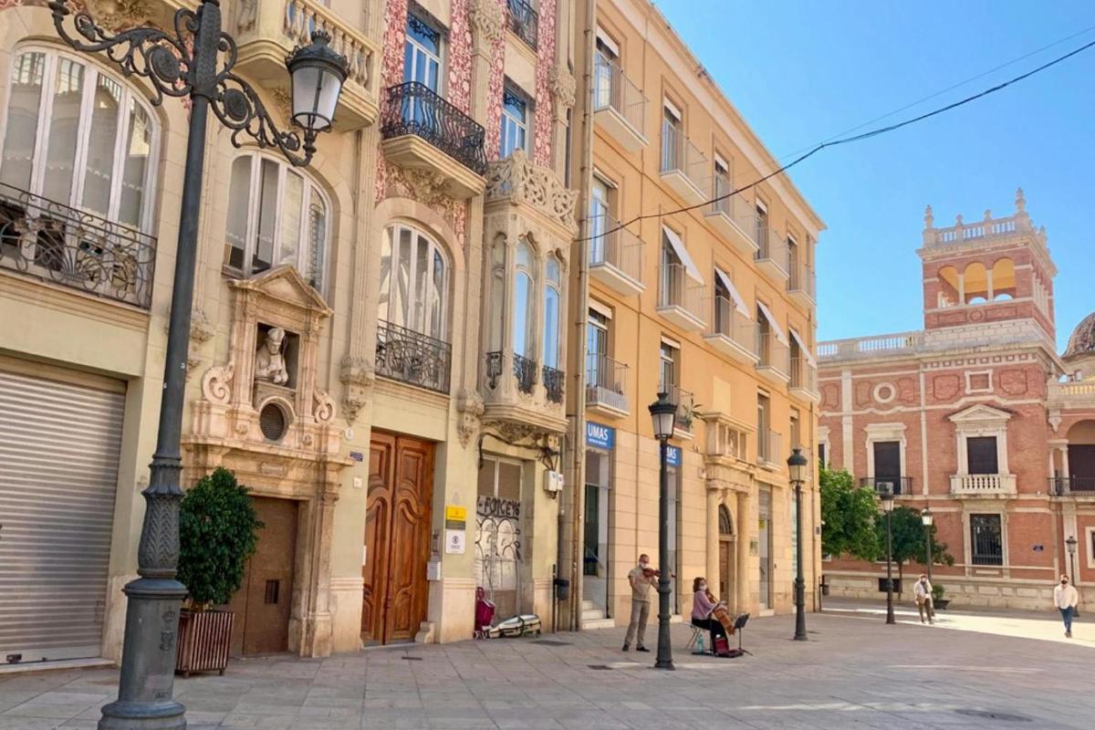 a group of buildings with people walking in a street