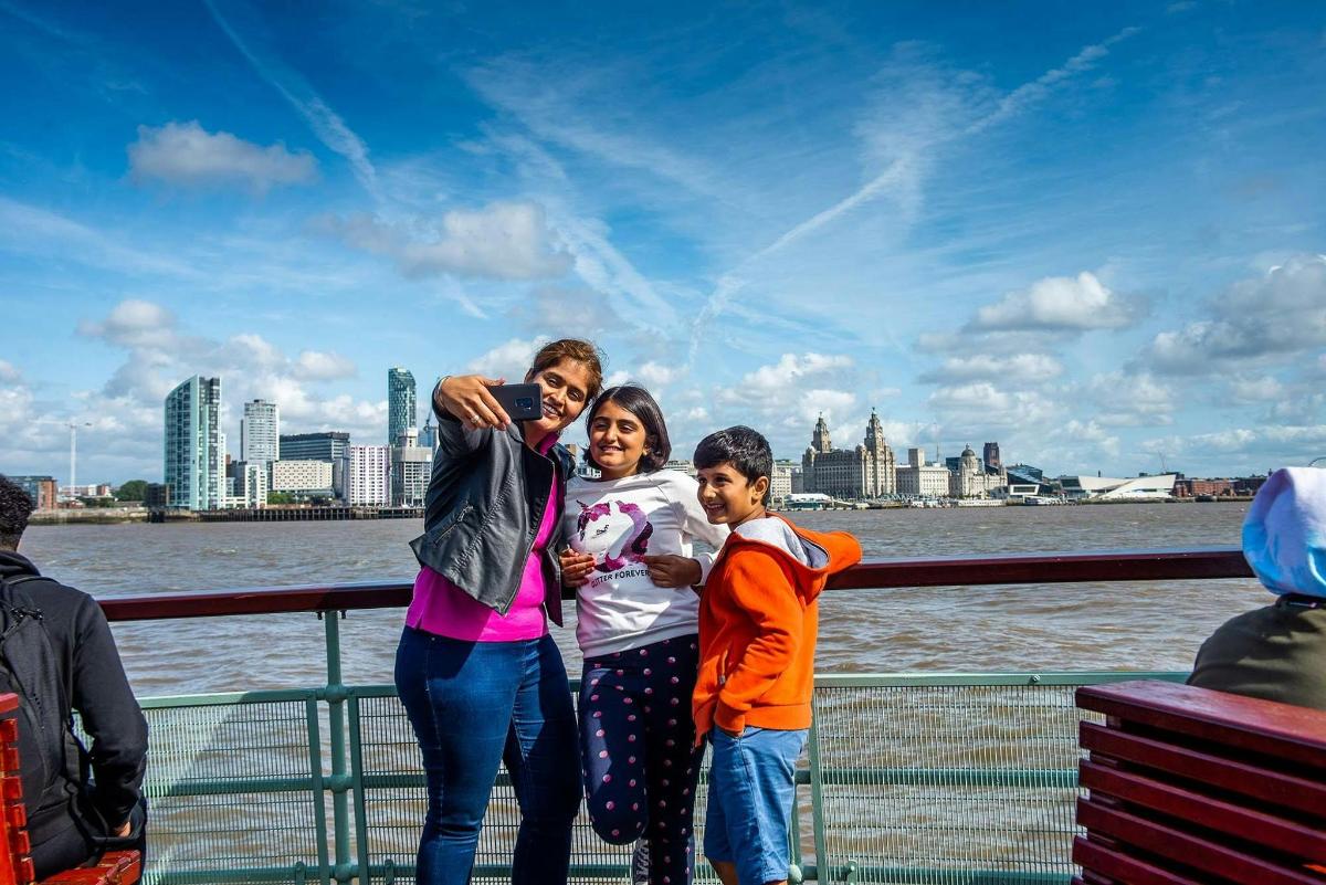 a woman and two children standing on a boat