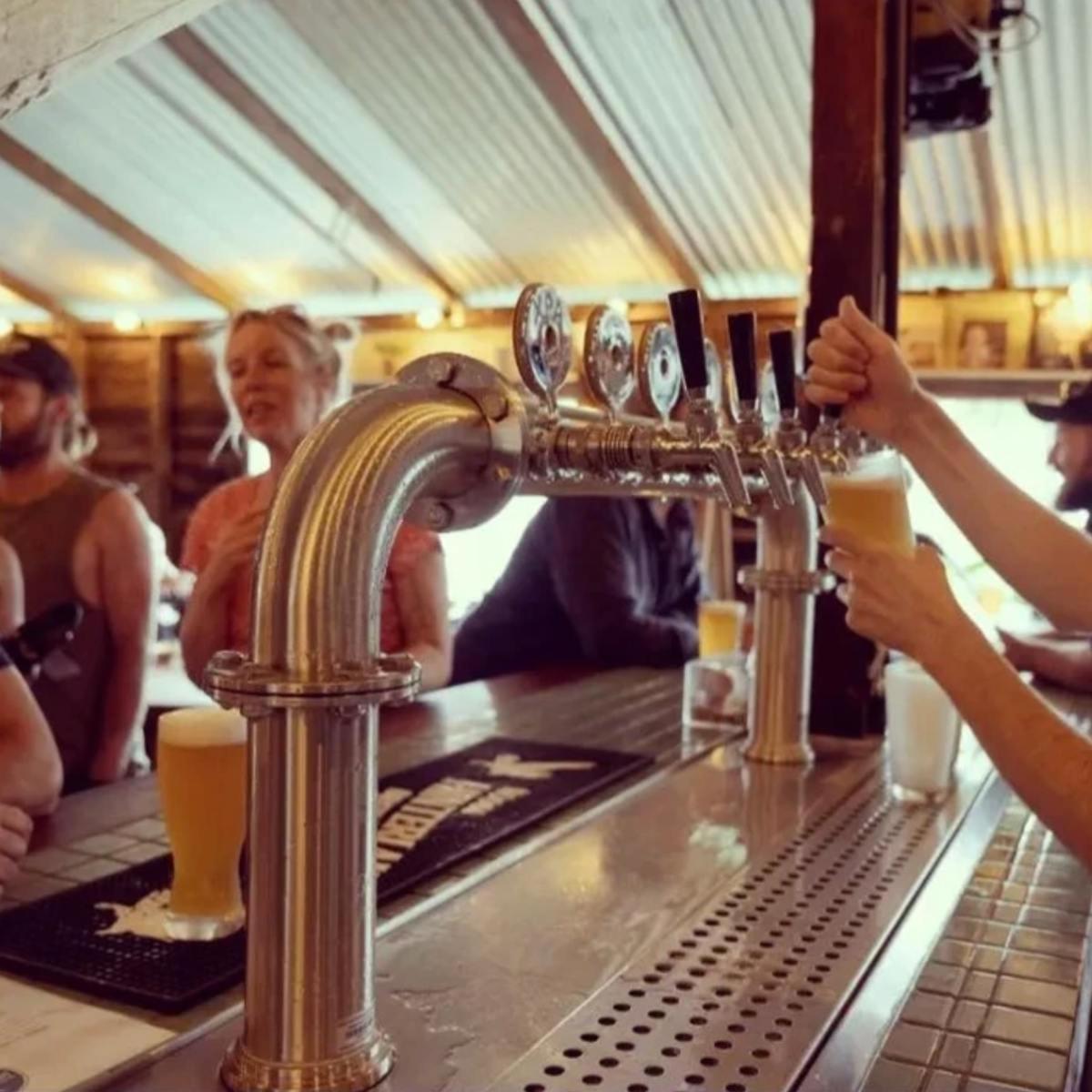 a group of people sitting at a bar with drinks