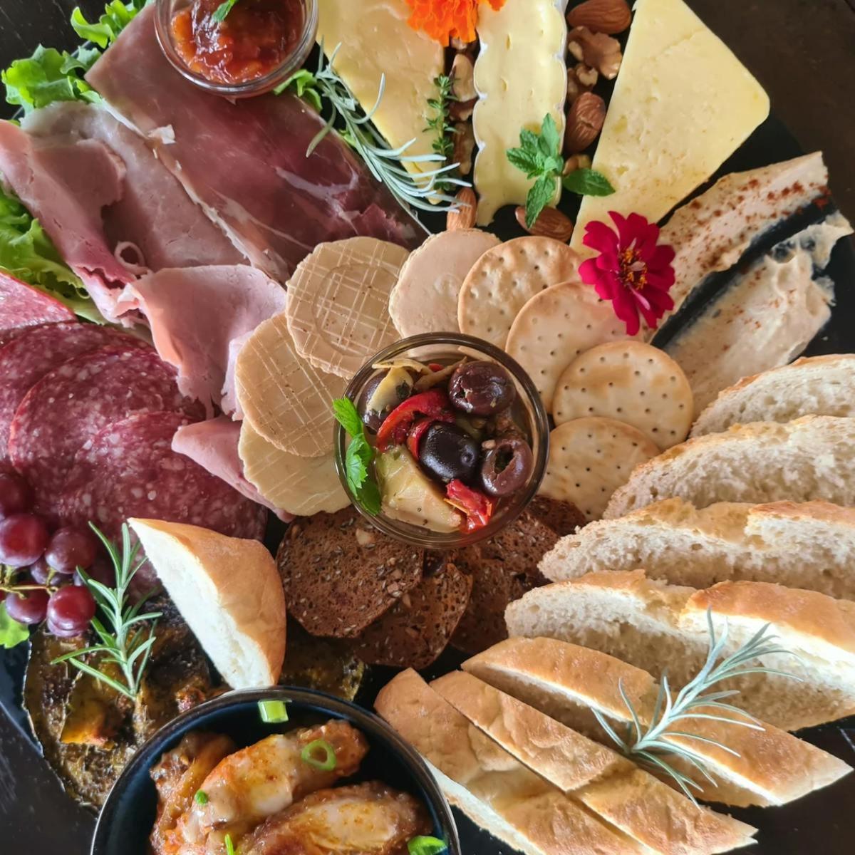 a plate of food with different types of meats and cheese