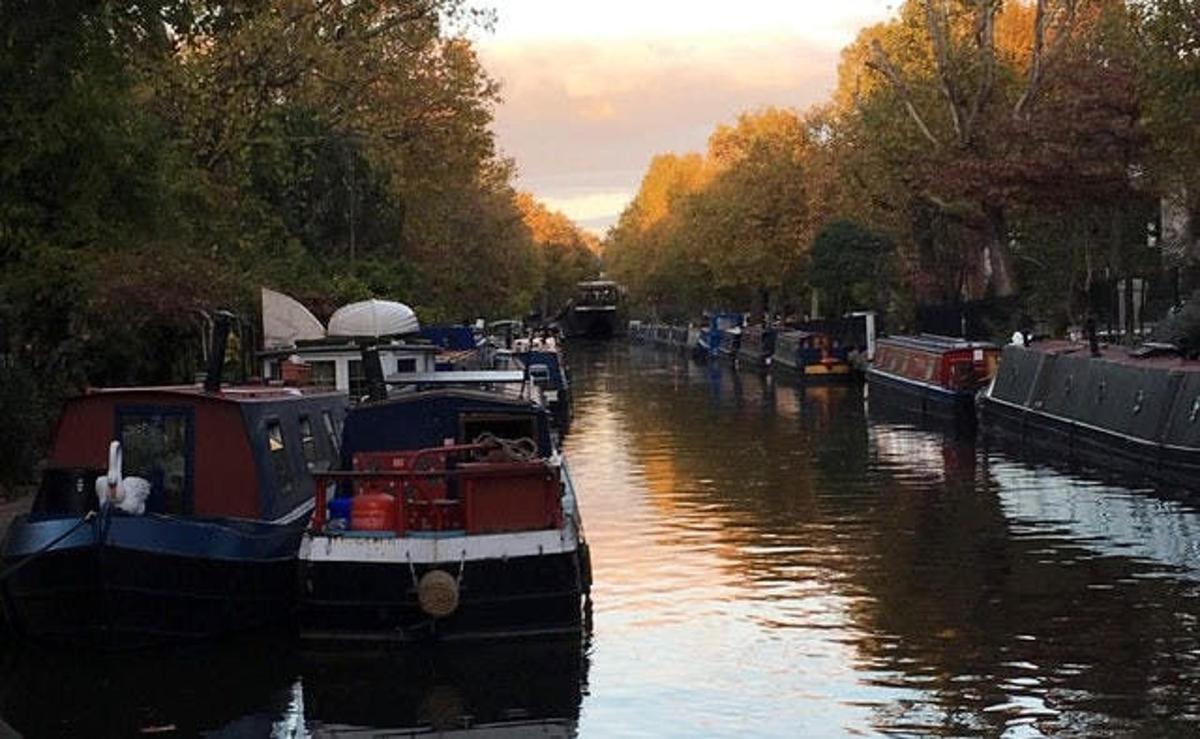 a couple of boats are docked in a canal