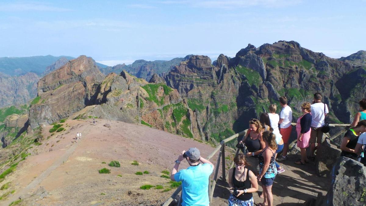 a group of people standing at the top of a mountain