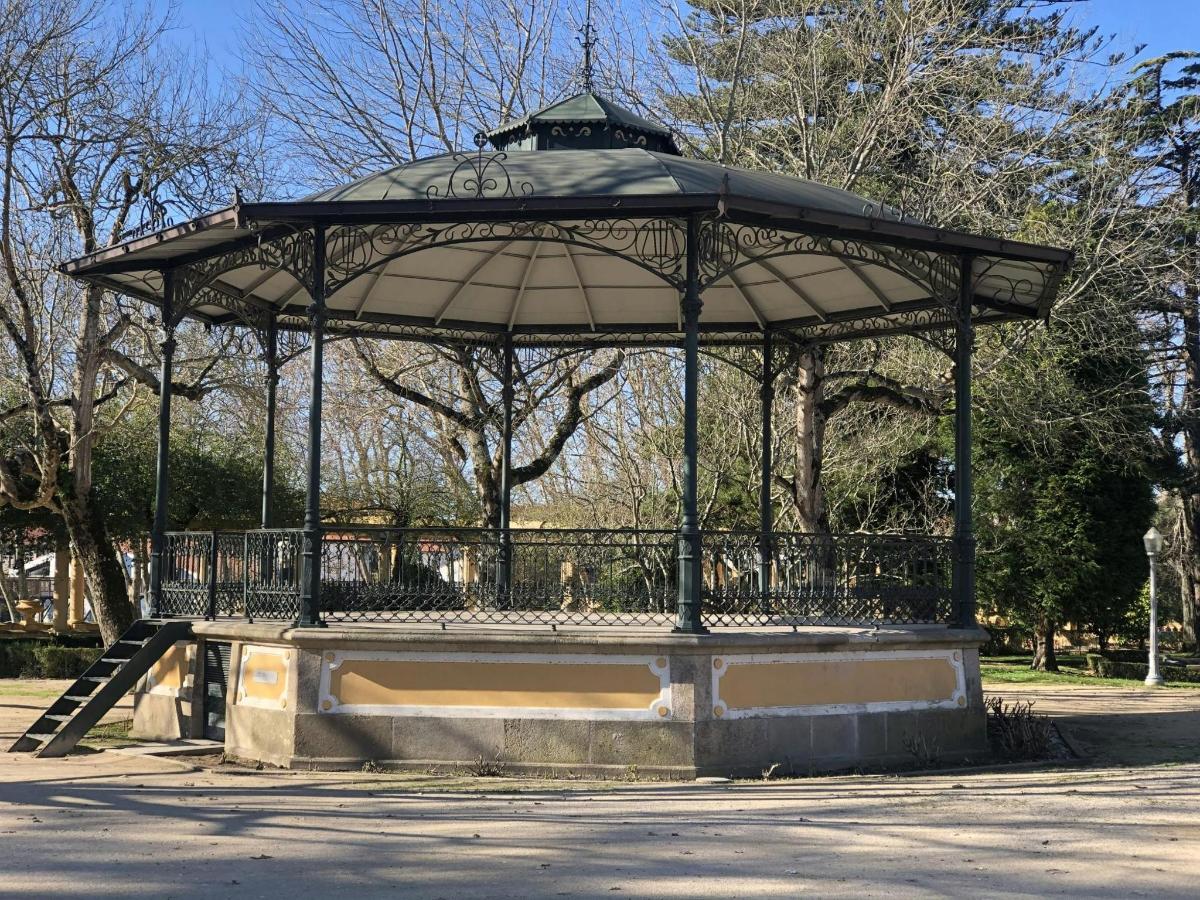 a gazebo in a park with a person in it
