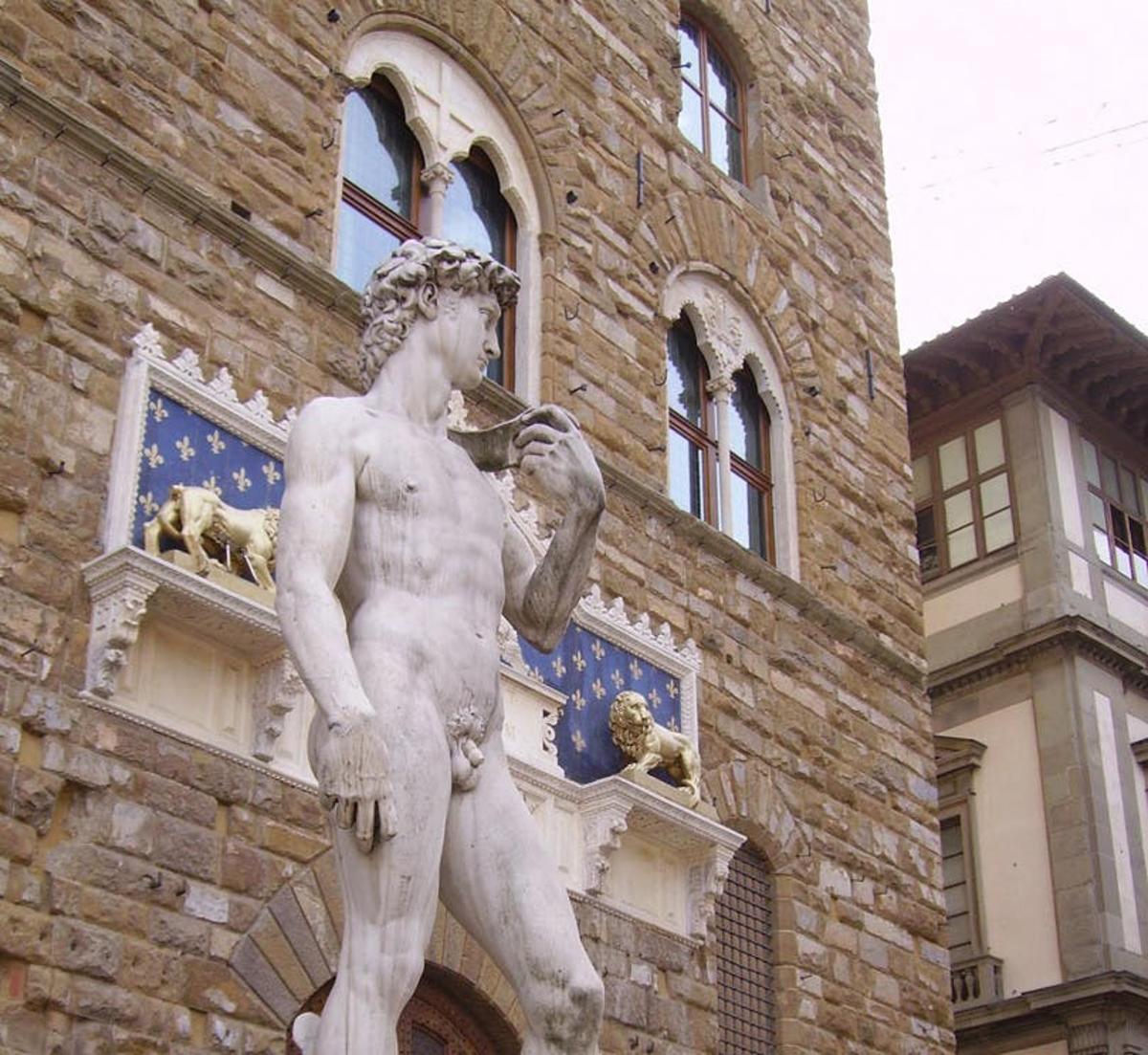 a statue of a man standing in front of a building