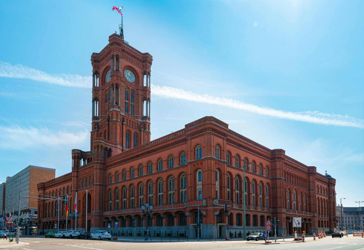 a large red brick building with a clock tower