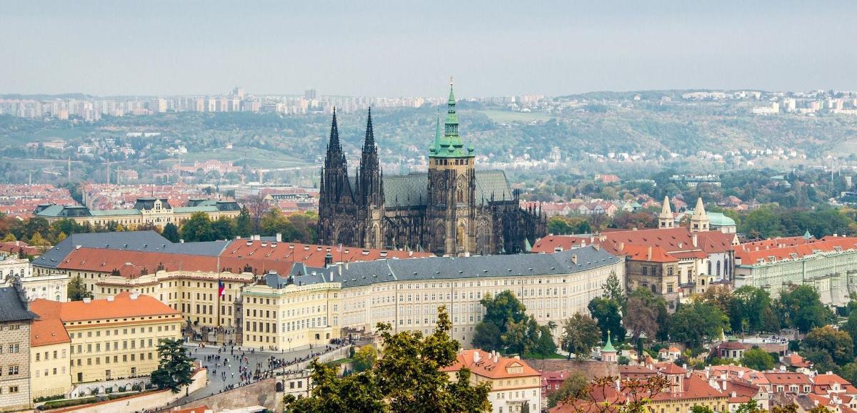 a view of a city with a large building and a church
