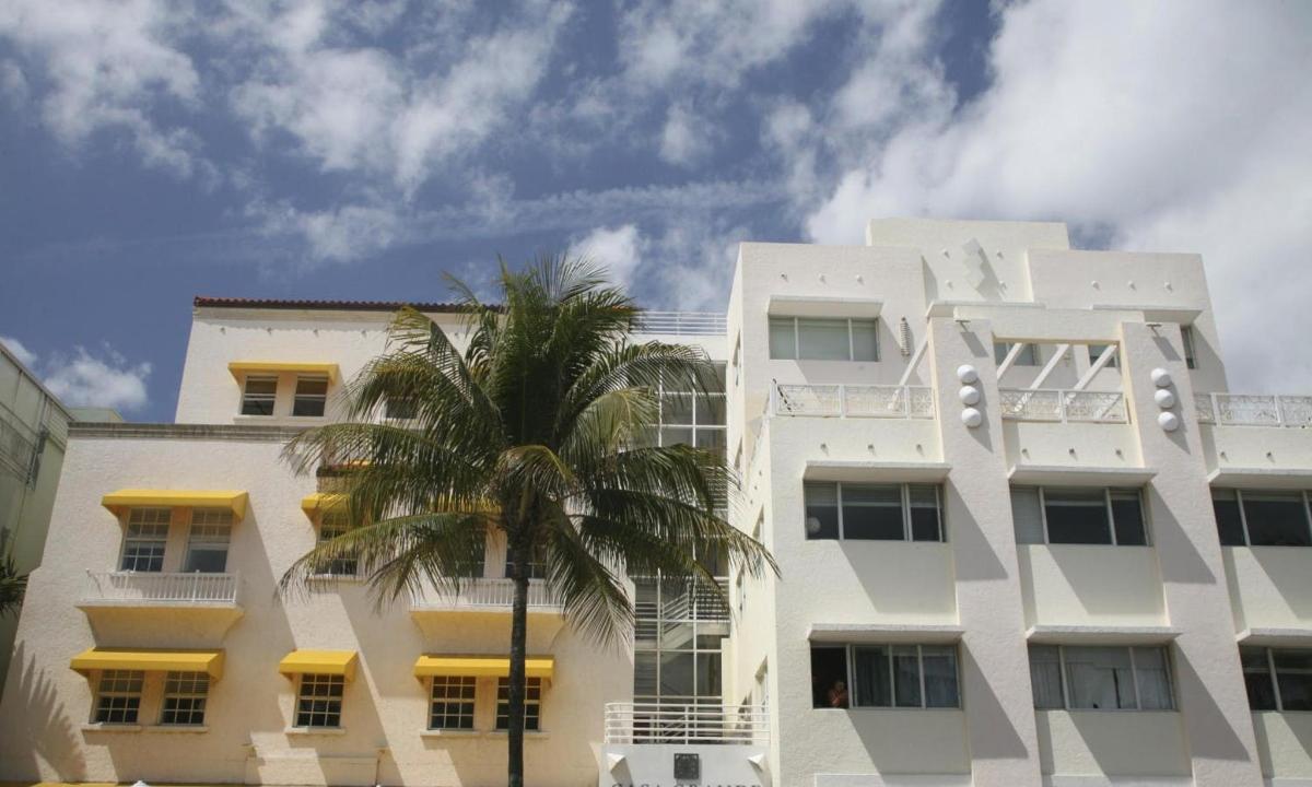 un edifici blanc amb una palmera al davant