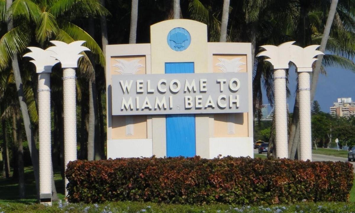 un rètol de benvinguda a Miami Beach davant de les palmeres