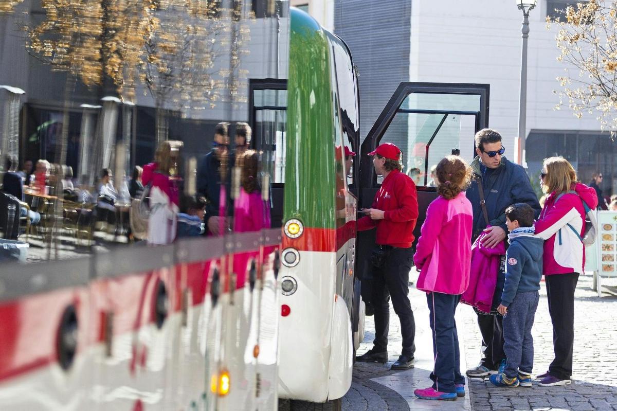 a group of people standing next to a bus