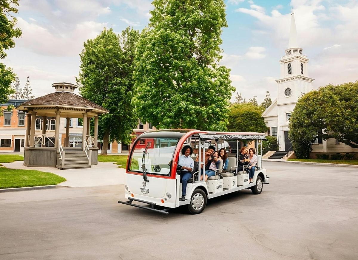 a group of people riding in a golf cart