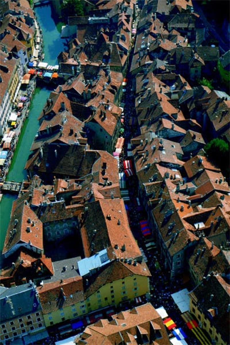 an aerial view of a city with buildings and a river