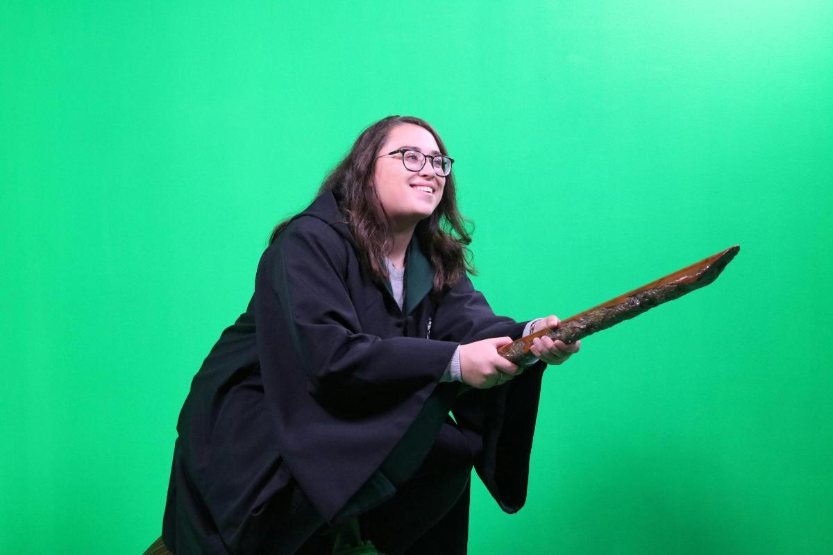 a woman in a witch costume holding a knife