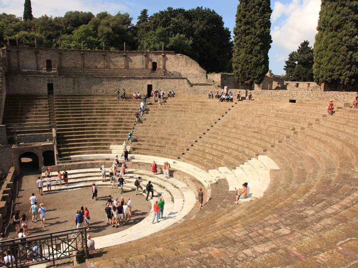a group of people walking around an amphitheater