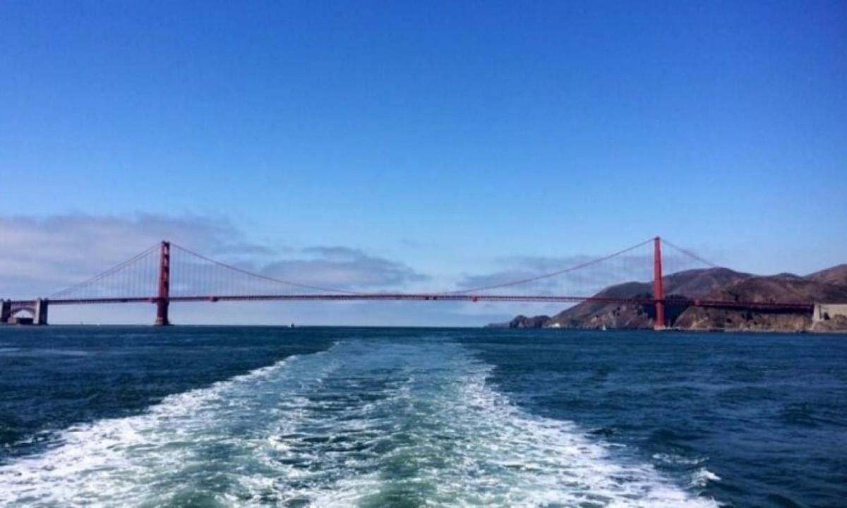 a boat in the water with a bridge in the background