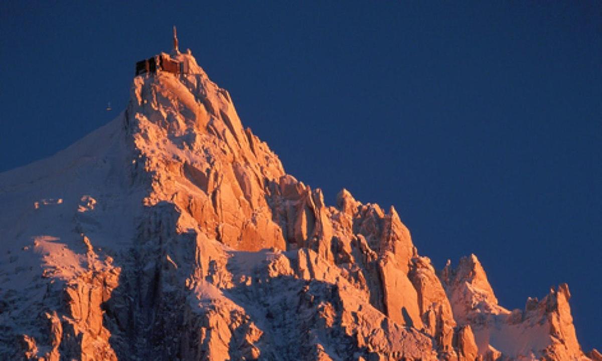 a tall mountain with a building on top of it