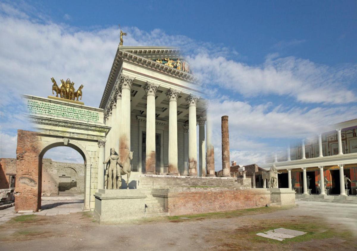 ein großes Gebäude mit Säulen und einem Bogen vor einem Gebäude