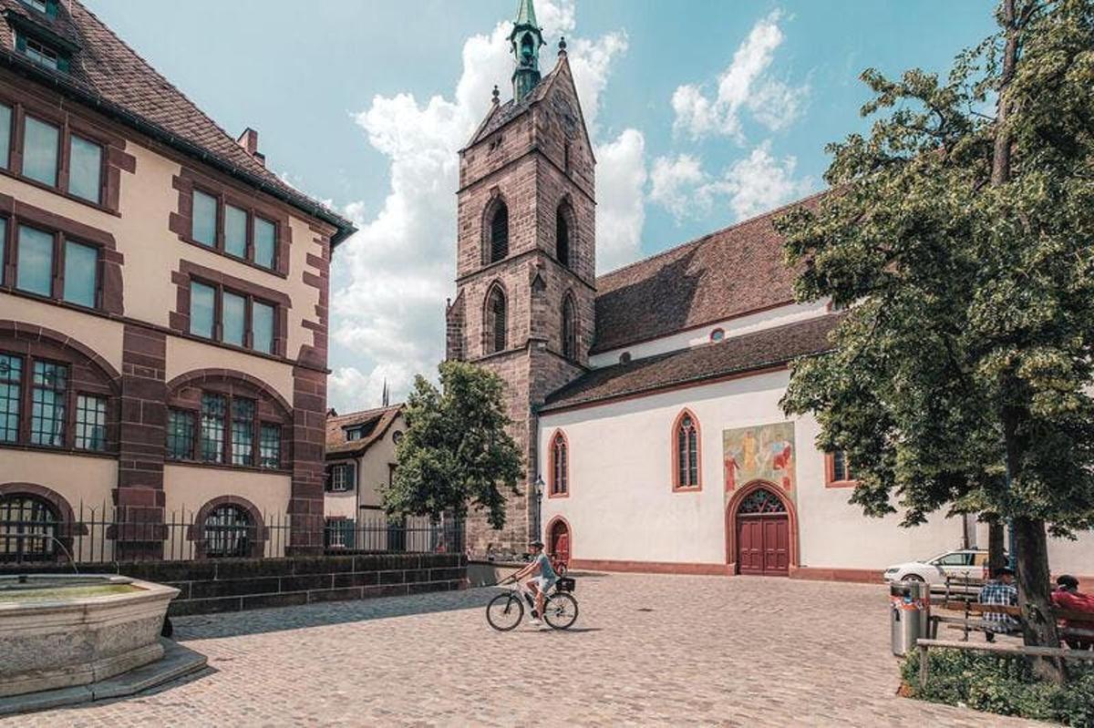 a person riding a bike in front of a church