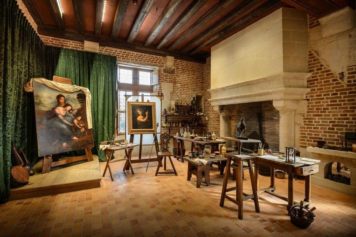 a room with a painting and tables and a fireplace
