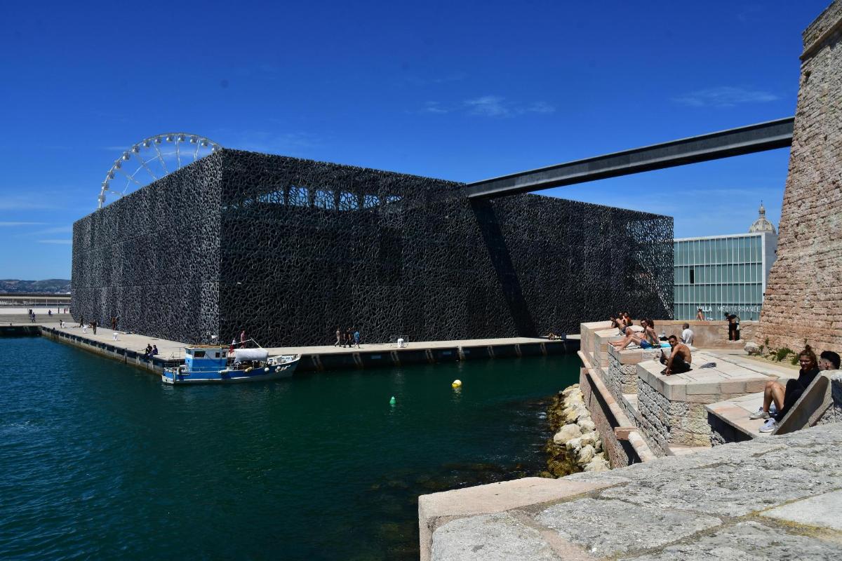 a building next to a body of water