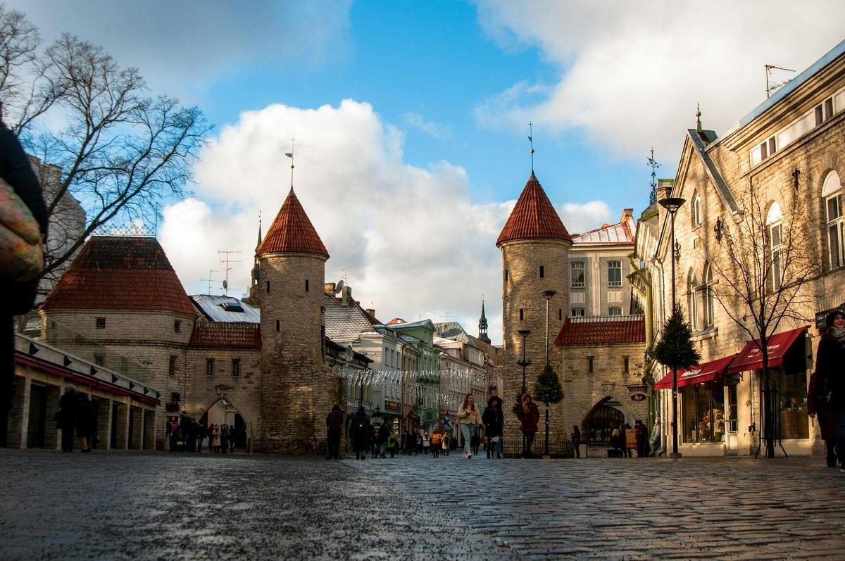 a cobblestone street in a city with two towers