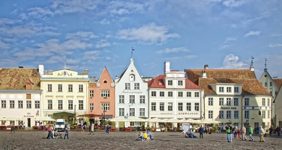 a group of buildings in a city with people walking