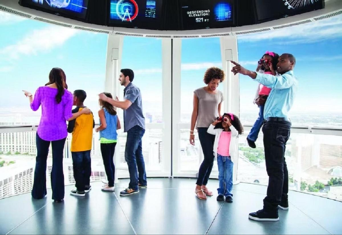 a group of people standing in front of a large window