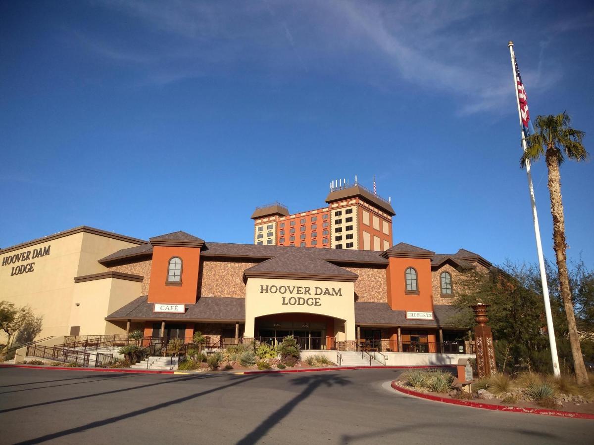 a hotel building with a tower in the background