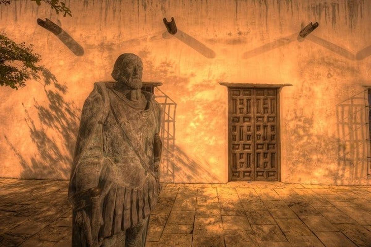 a statue in front of a building with a door