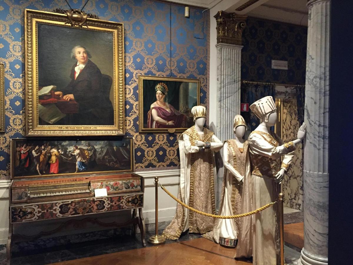 muzeum se dvěma sochami před obrazem