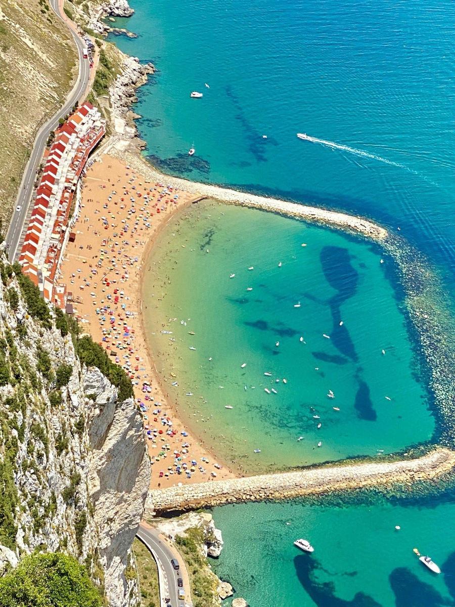 an aerial view of a beach with blue water