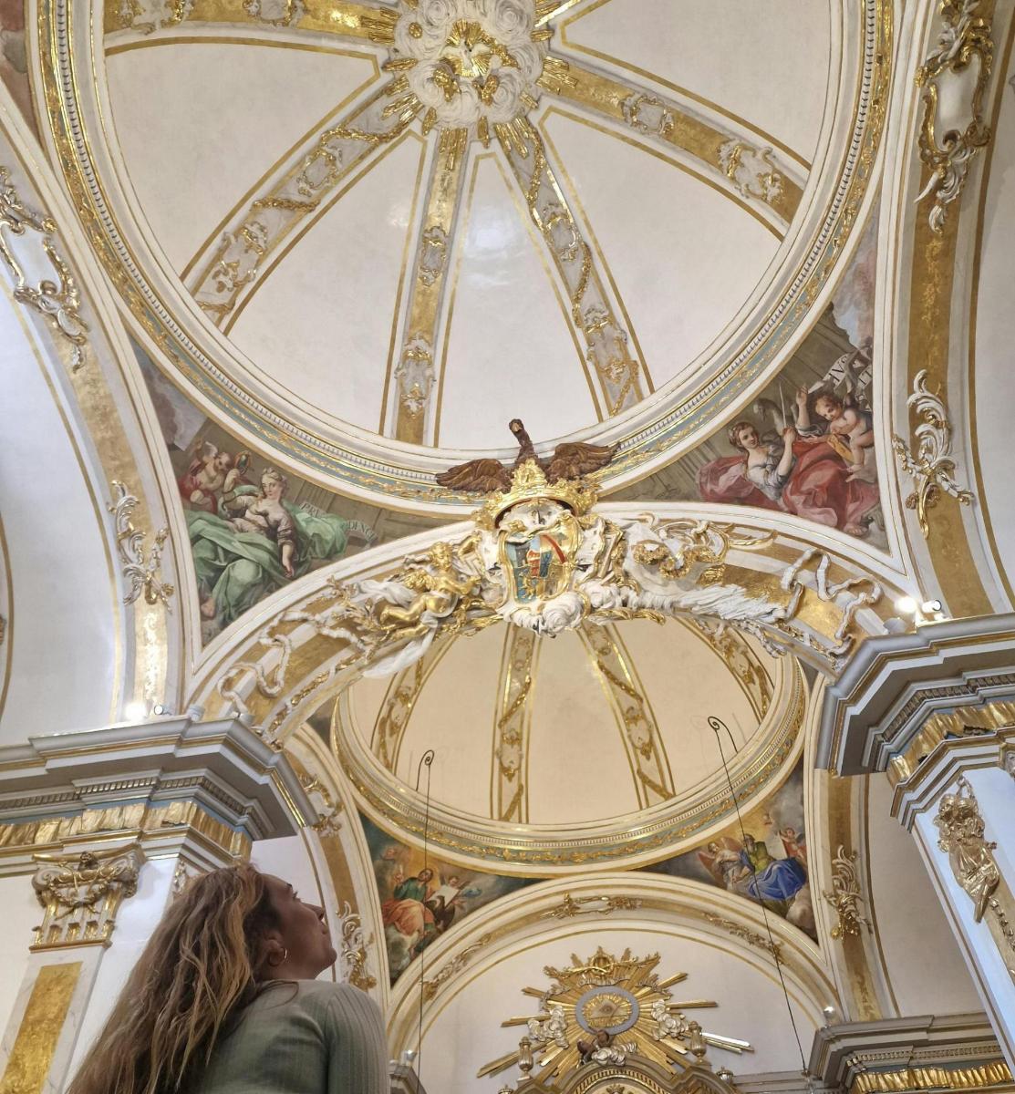a woman looking up at the ceiling of a building