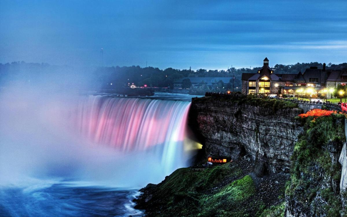 a view of a waterfall at night with a rainbow