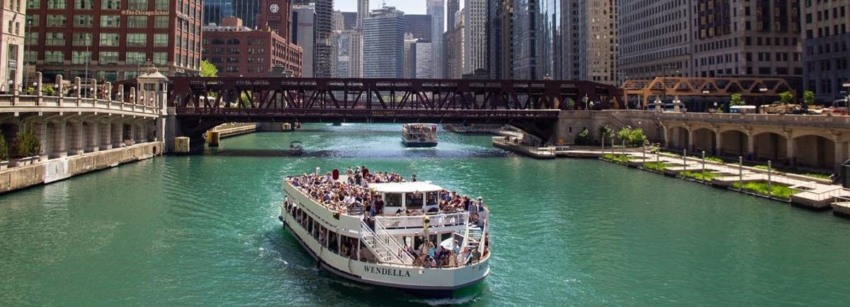 a boat traveling down a river in a city