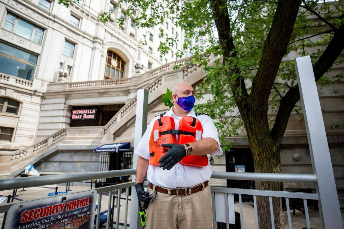 a man wearing a mask standing in front of a building