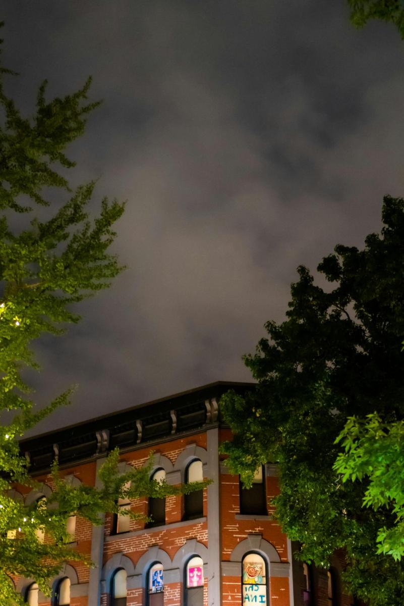 a large brick building with trees in front of it